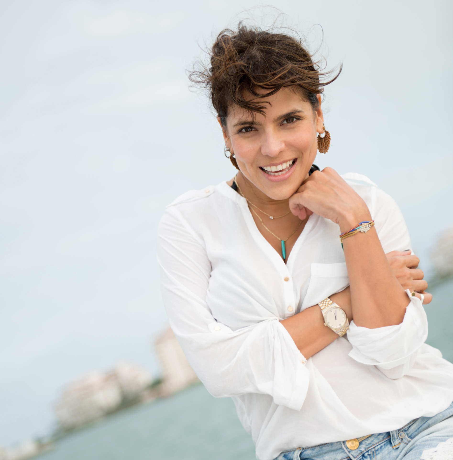 Confident woman smiling by the sea